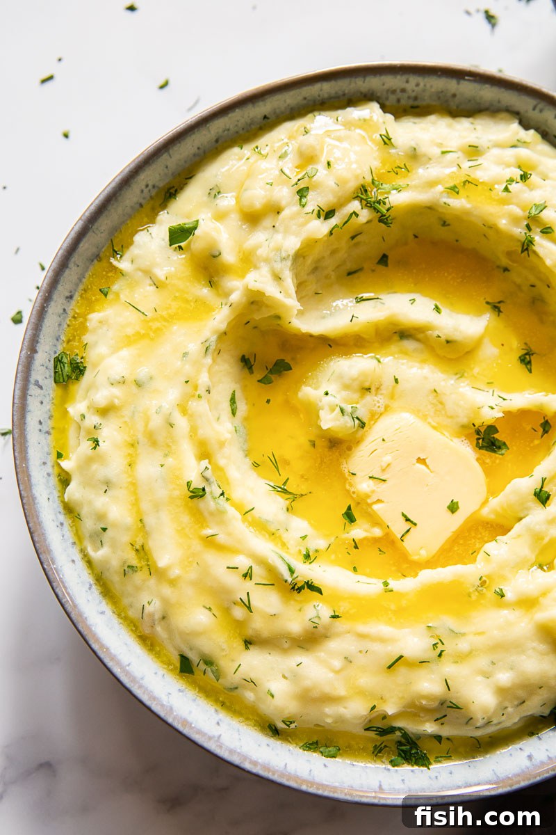 Savory Garlic Herb Mash 5 Creamy mashed potatoes generously topped with melted butter and a sprinkle of fresh herbs.