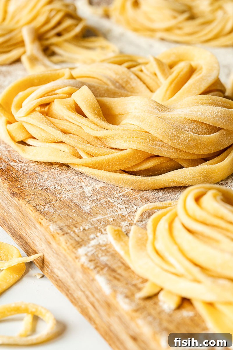 Perfect Fresh Pasta from Scratch 3 Neatly bundled nests of fresh tagliatelle pasta, dusted with flour