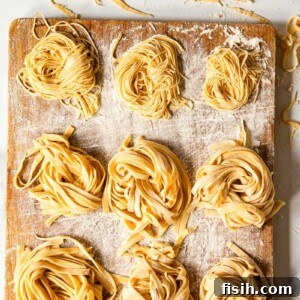 Perfect Fresh Pasta from Scratch 8 Homemade tagliatelle and tagliolini artfully displayed on a wooden board