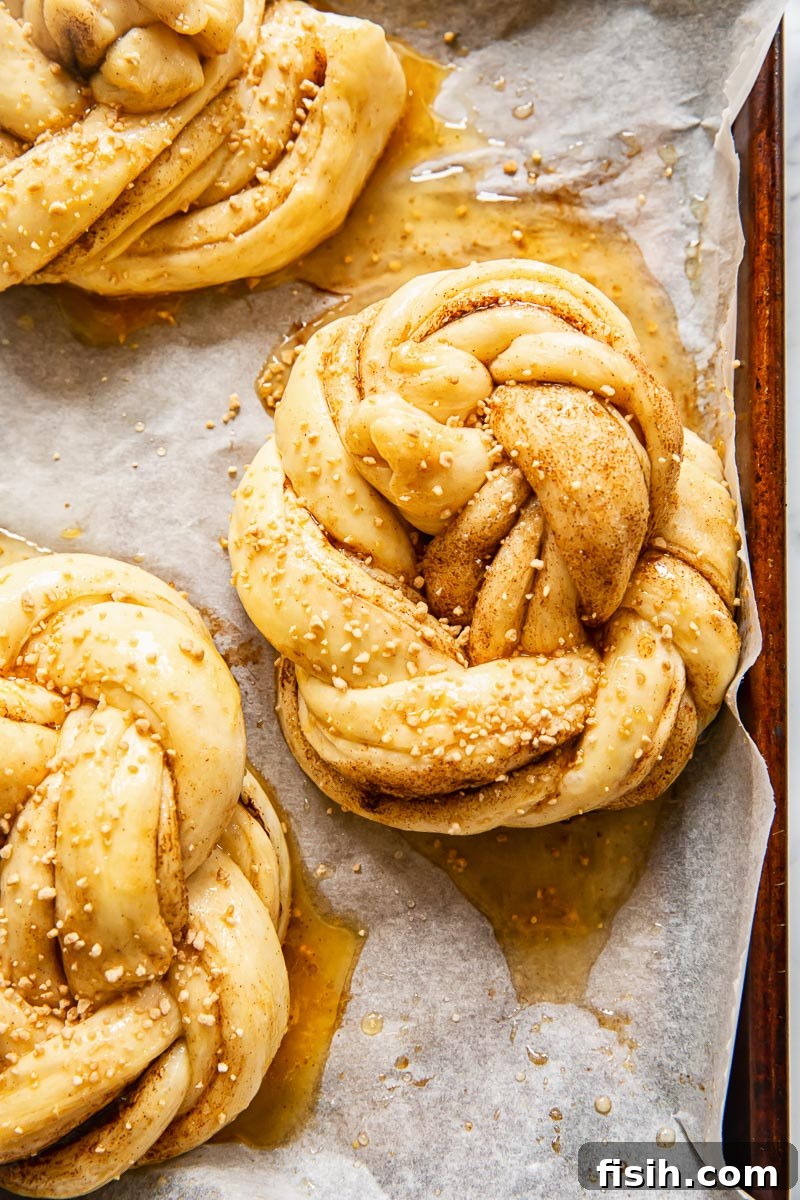 Fluffy Cinnamon Buns From Scratch 4 unbaked cinnamon buns on baking sheet