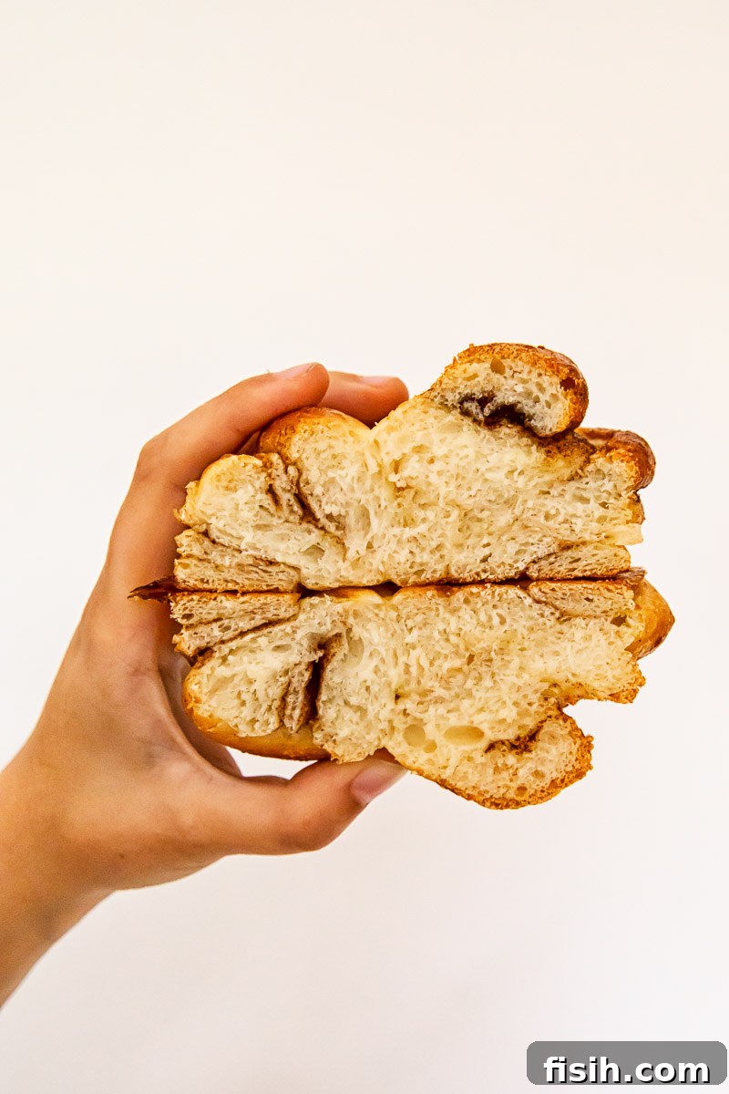 Fluffy Cinnamon Buns From Scratch 5 cinnamon bun cut in half with interior crumb showing