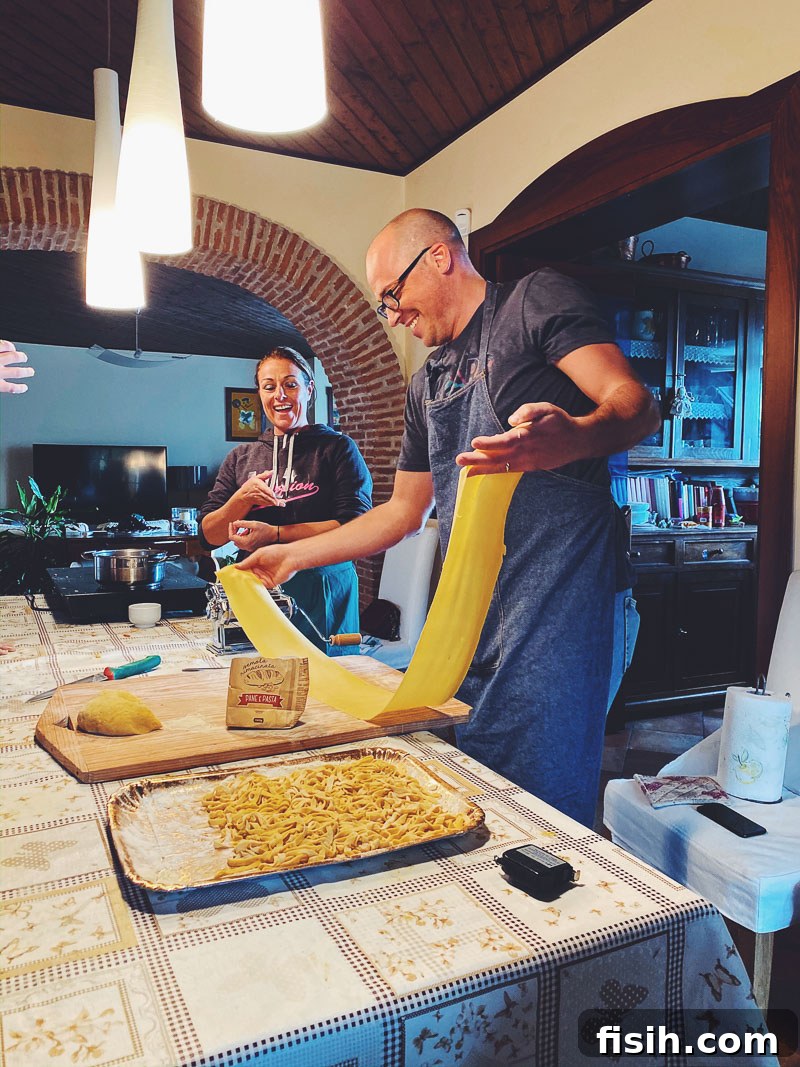 A skilled man meticulously making fresh pasta by hand in a rustic Italian kitchen, showcasing traditional Campanian culinary craftsmanship.
