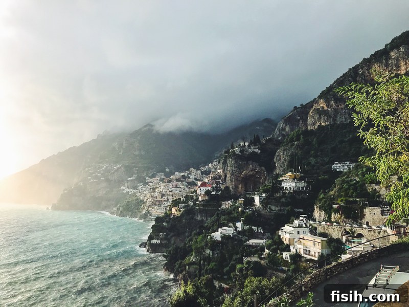 The breathtaking coastline of Amalfi, Italy, showcasing dramatic cliffs, vibrant blue sea, and charming coastal architecture nestled into the hillsides.