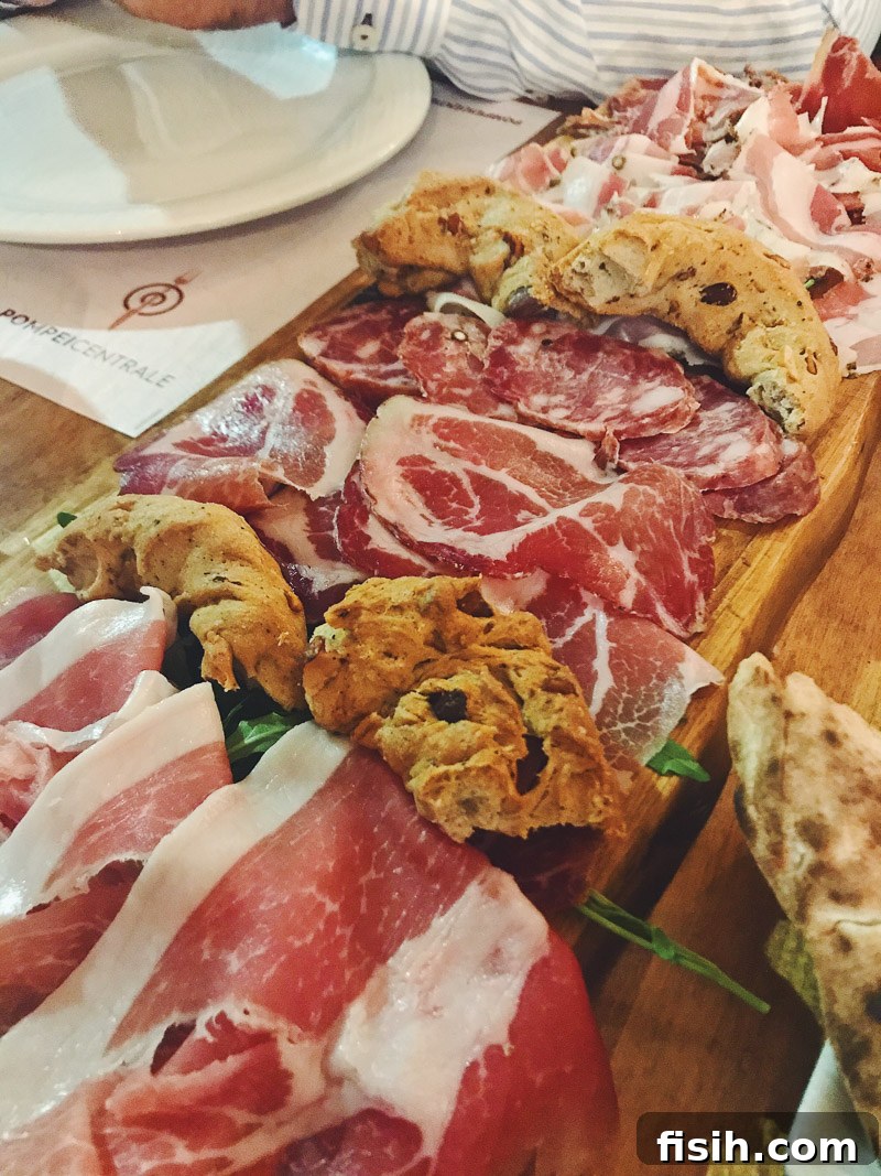 An inviting antipasti platter featuring a generous selection of cured meats, fresh local cheeses, olives, and artisanal bread, perfect for pairing with regional wines.