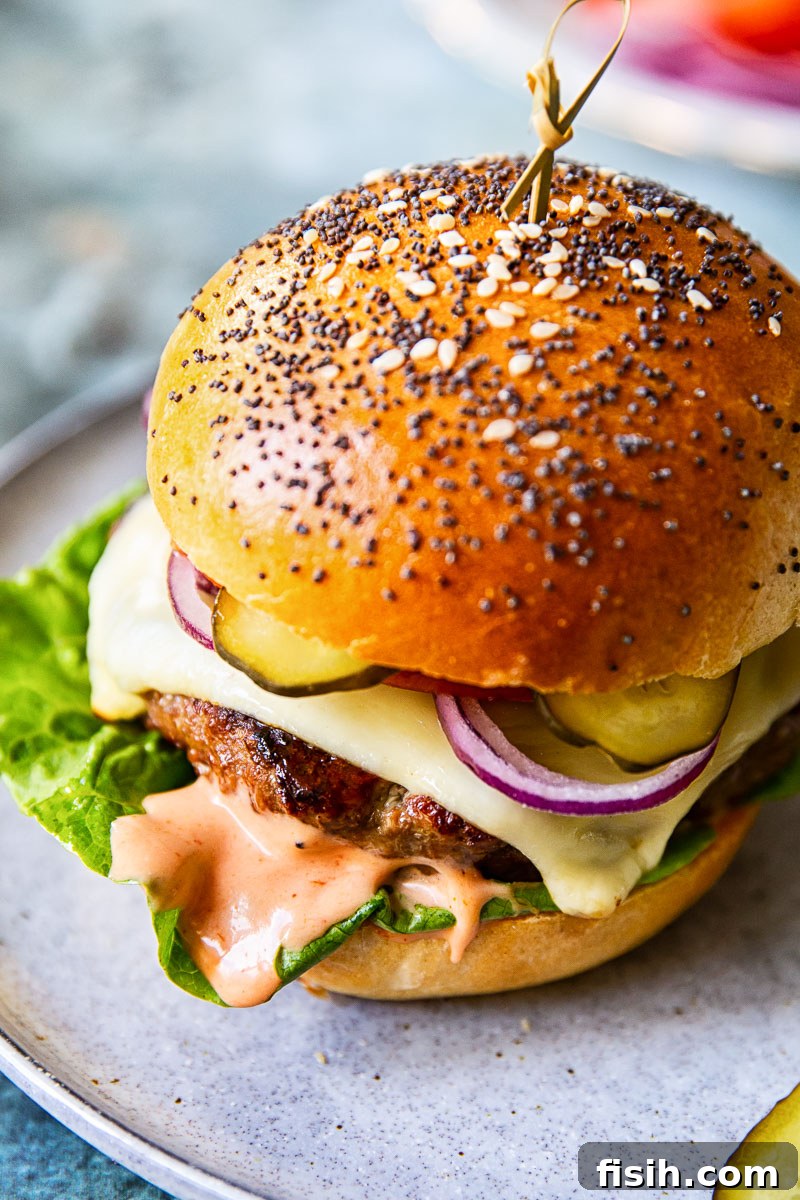 top down view of a cheeseburger with sauce spilling out