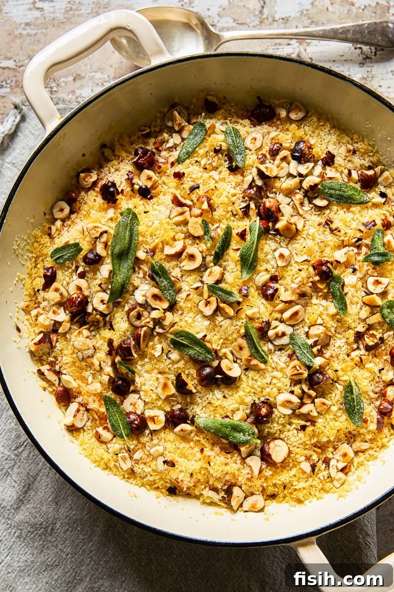 sweet potato casserole with breadcrumb and nut topping in cream pan