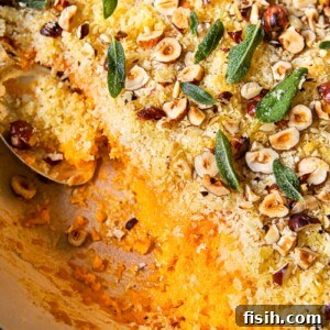 top down view of sweet potato casserole with breadcrumbs, hazelnuts and sage leaves