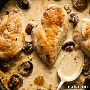 Chicken Supreme in Velvety White Wine Mushroom Cream 7 chicken breasts with mushrooms in cream sauce in skillet