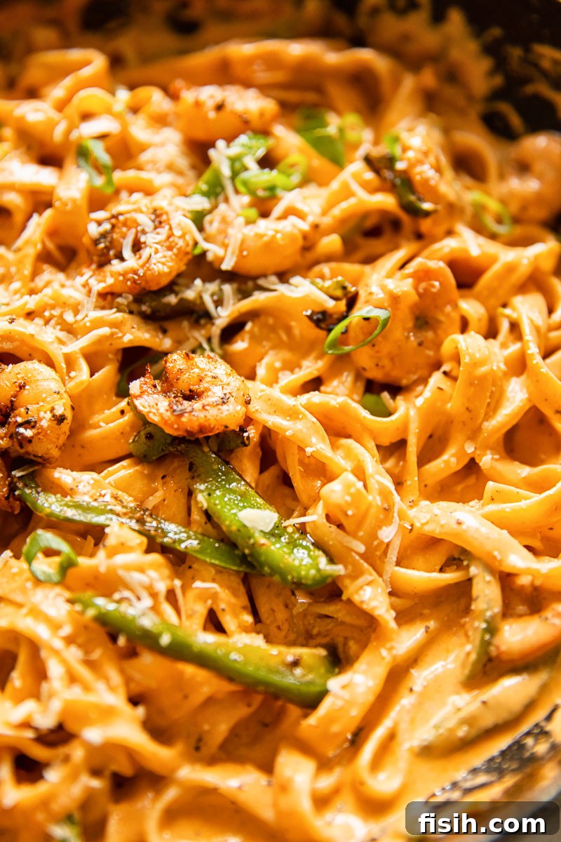 Bayou Blast Shrimp Pasta 4 Close-up of creamy Cajun shrimp pasta with green onions and bell peppers