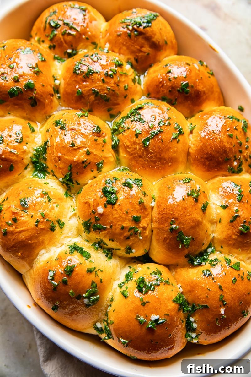 top down view of dinner rolls brushed with melted herb and garlic butter