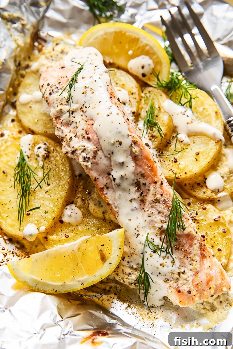 Campfire Salmon and Potato Foil Packs 2 salmon and potatoes in foil packet ready to be cooked