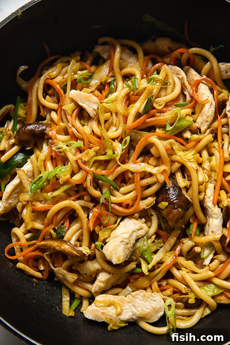 Wok-Fired Chicken Udon Noodles 2 Savoury chicken yaki udon noodles with mushrooms, ready to eat in a bowl