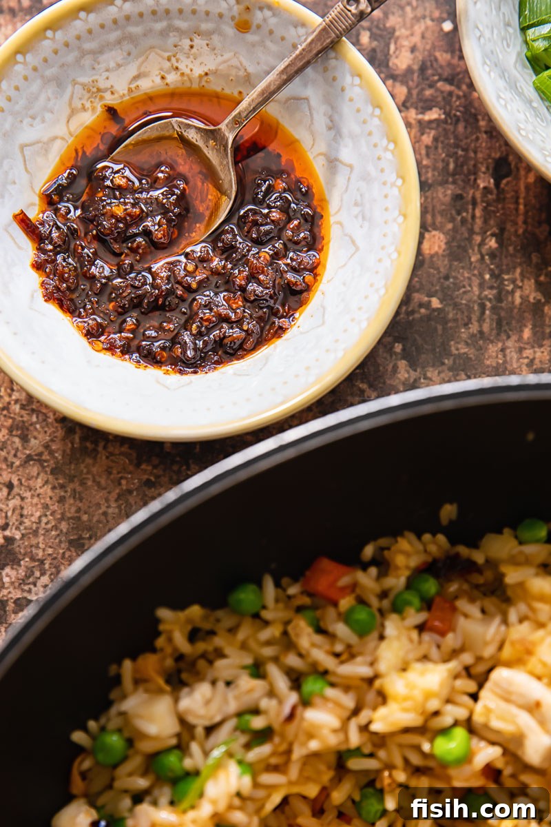 Wok-Kissed Chicken Fried Rice 3 Chinese chilli oil and fried rice in a pan