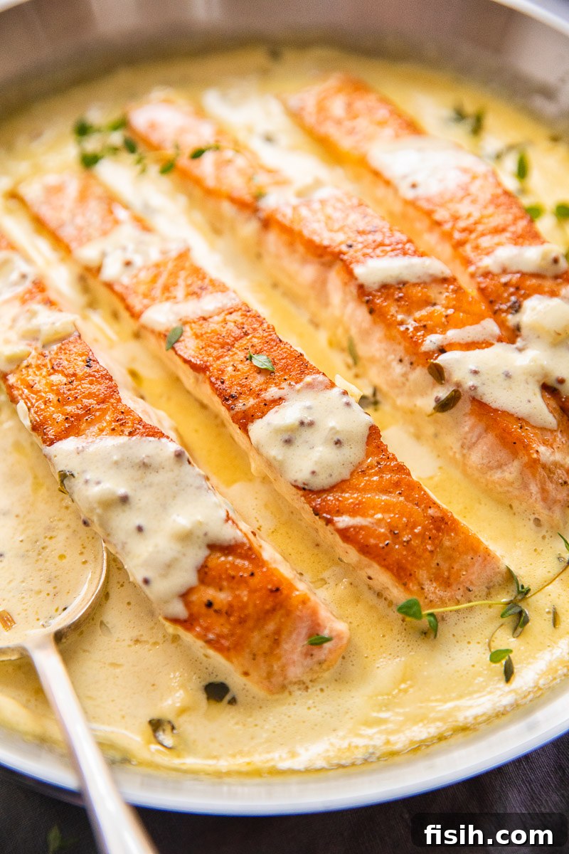 Pan-Seared Salmon with Tangy Creamy Mustard 2 Pan-Seared Salmon with Creamy Mustard Sauce, garnished with fresh herbs.