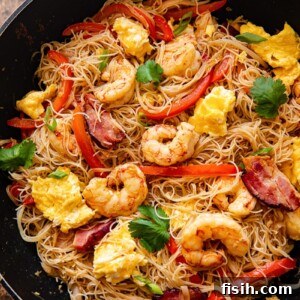 Top down view of Singapore Noodles in a wok
