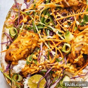 top down view of grilled chicken on top of salad