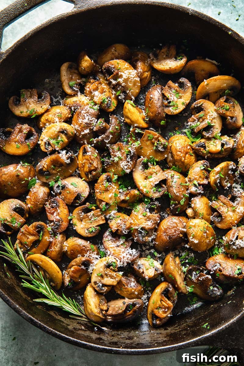 Sautéed Garlic Parmesan Mushrooms 3 Cooked pan-fried garlic mushrooms nestled in a cast iron skillet