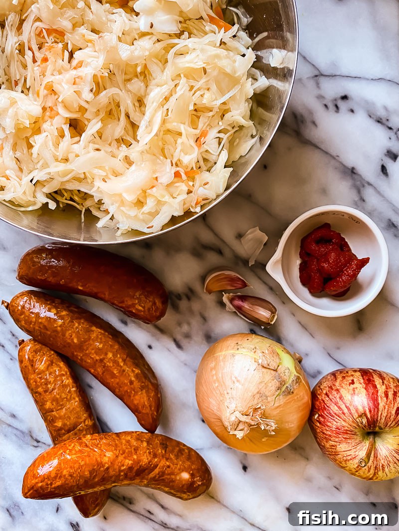 Savory Kielbasa with Tangy Sauerkraut 3 Ingredients for Kielbasa and Sauerkraut: sauerkraut in a bowl, kielbasa, an onion, an apple, tomato paste and garlic