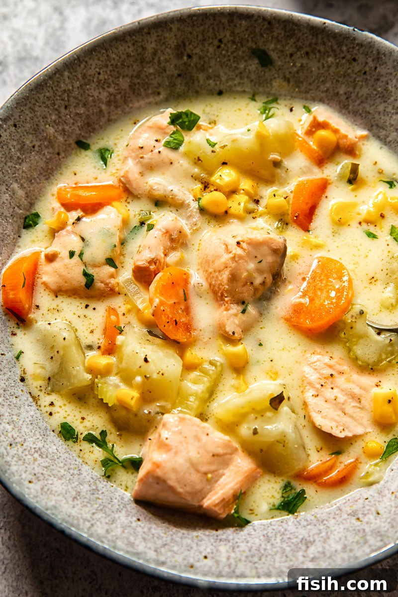 Hearty Salmon Chowder 4 A close-up view of the creamy salmon chowder, highlighting the tender salmon pieces, corn, and potatoes.