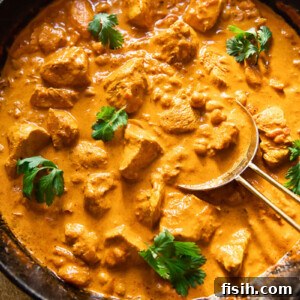 Top-down view of creamy homemade Chicken Tikka Masala in a pan.