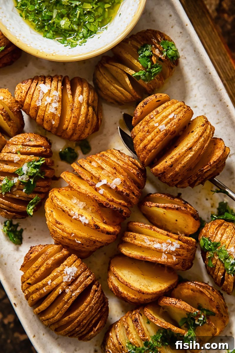 close up of potatoes on a platter sprinkles with sea salt and topped with gremolata