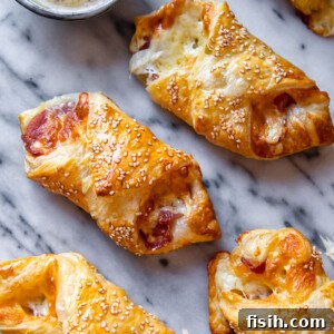 bacon and cheese turnovers on marble background with honey mustard sauce