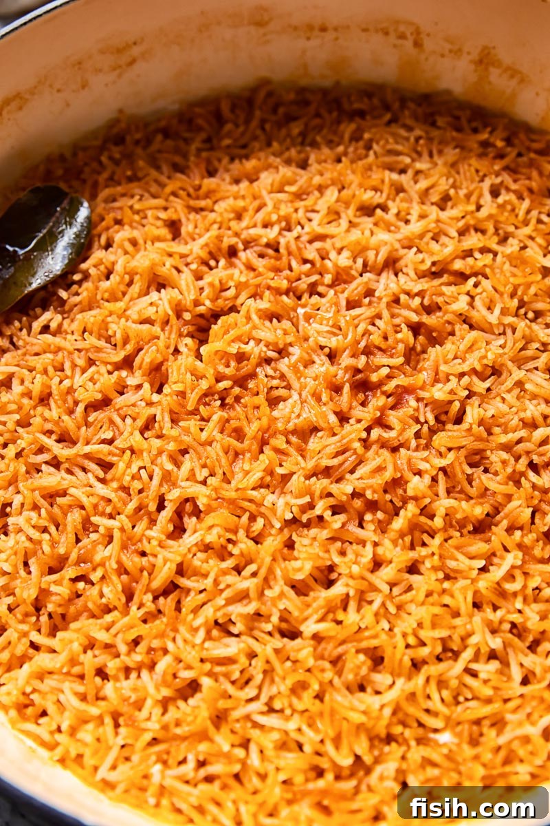Orange Peri Peri rice cooking in a pan