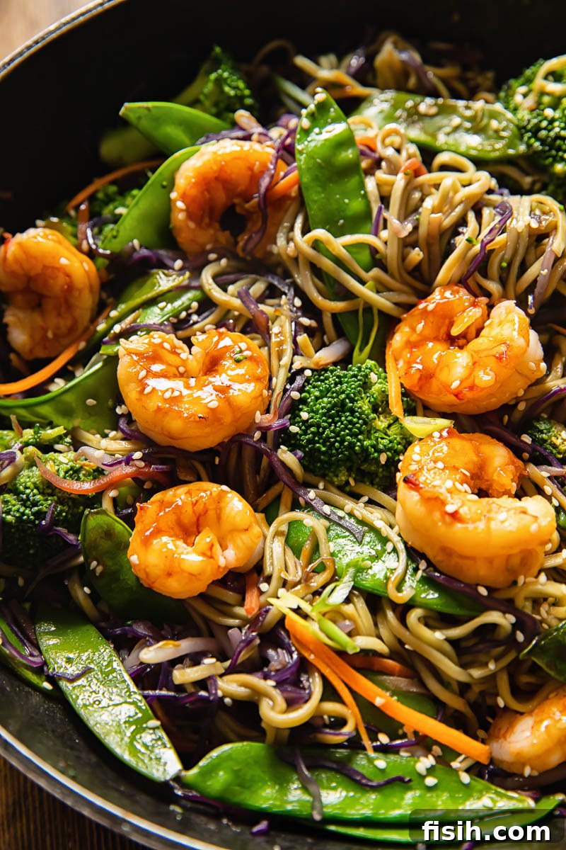 Sizzling Prawn Noodle Stir-Fry 5 A close-up shot of a serving of Shrimp Noodle Stir Fry, highlighting the fresh ingredients and vibrant colors.
