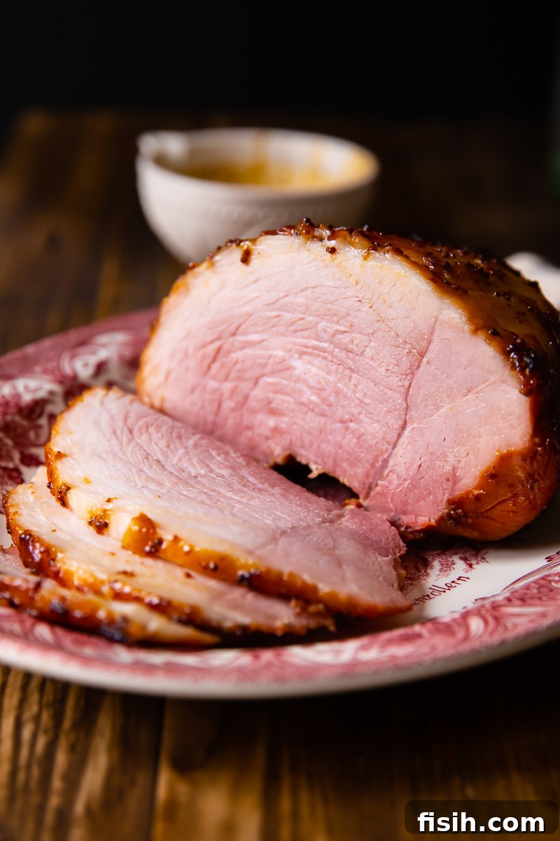 side view of sliced ham on a platter, ready to serve