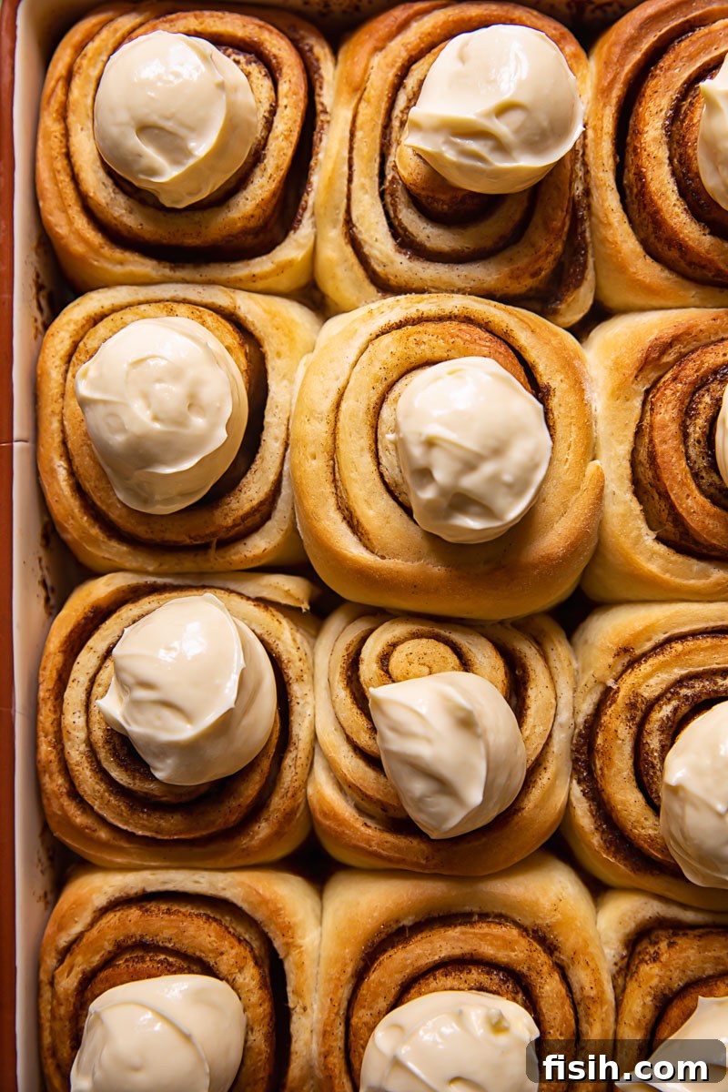 cinnamon rolls with dollops of icing on top