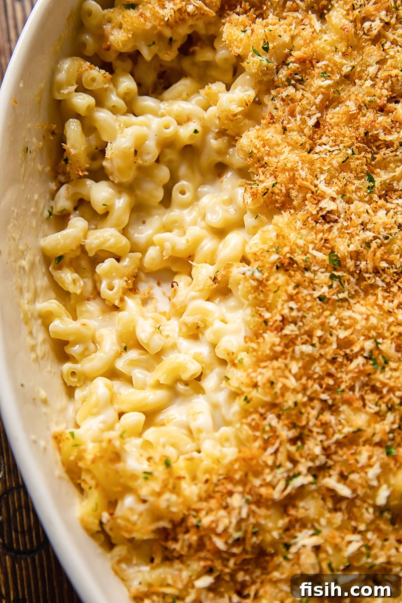 Golden Crusted Mac and Cheese 2 Top-down view of golden baked macaroni and cheese with a generous, crispy breadcrumb topping, ready to be served from a casserole dish.