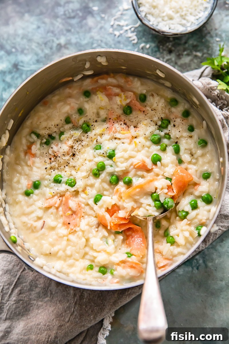 top down view of salmon and pea risotto in a pan 