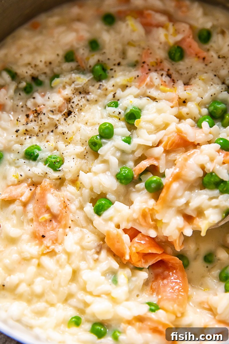 close up of smoked salmon risotto with green peas