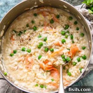 top down view of salmon and pea risotto in a pan
