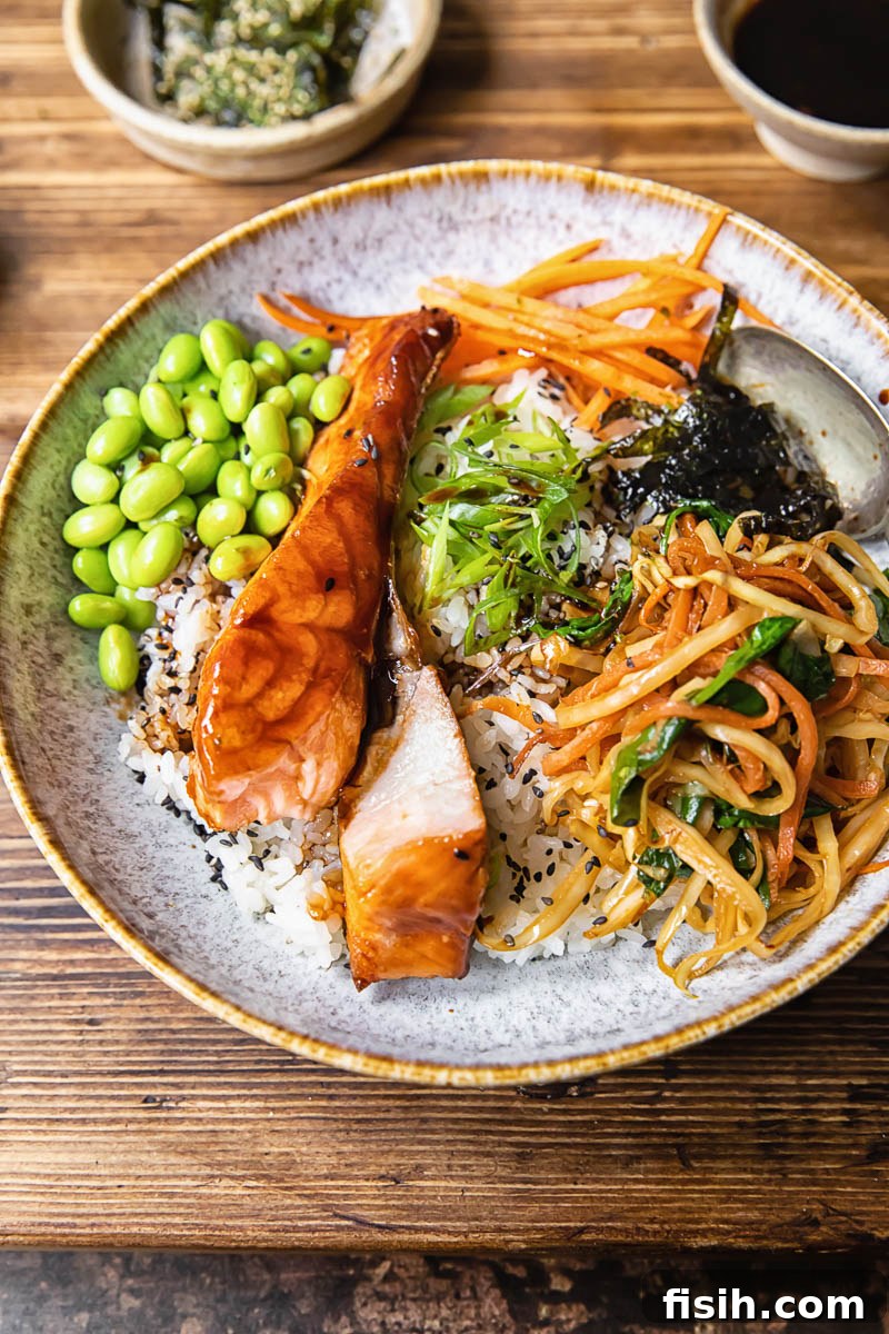 teriyaki salmon with rice and vegetables in a bowl