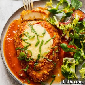 chicken parmesan on a plate with salad