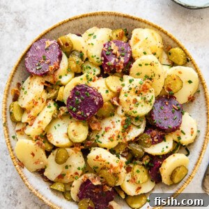 Top-down view of potato salad with white and purple potatoes