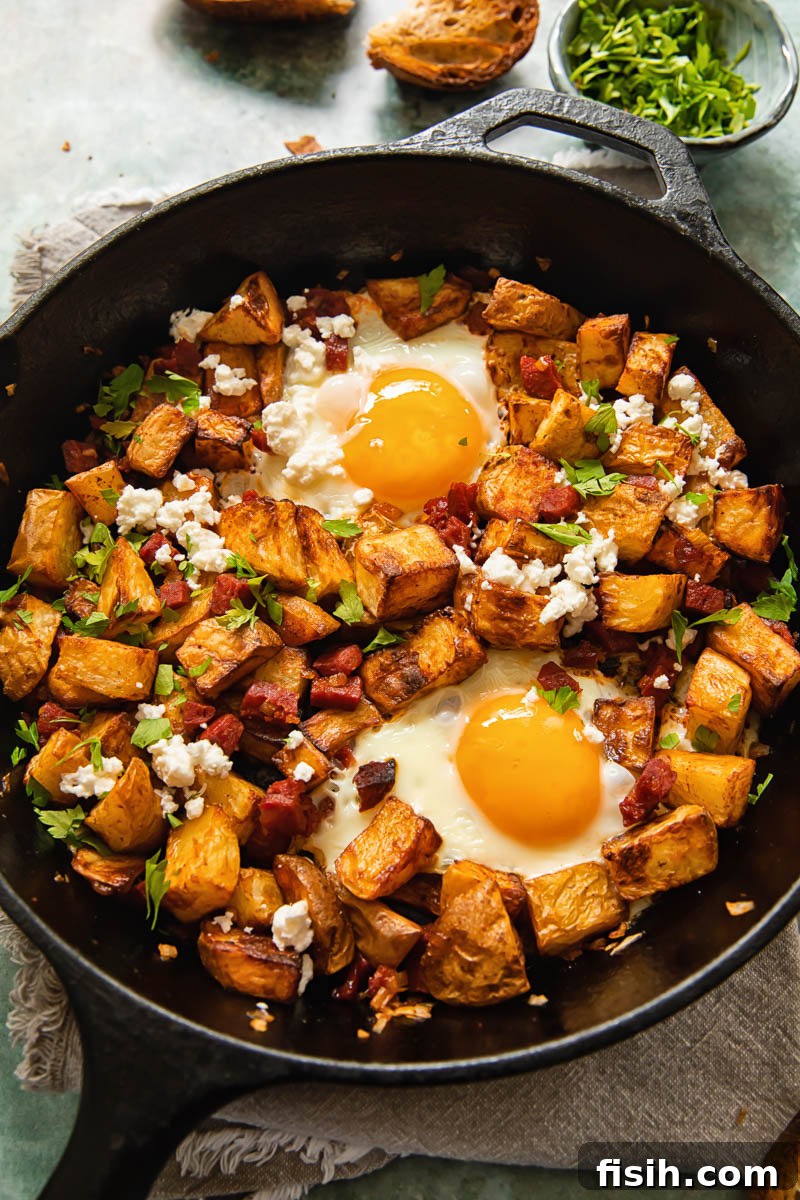 Savory Chorizo Hash with Tangy Feta 4 top down view of a skillet with diced potatoes, chorizo and egg with feta