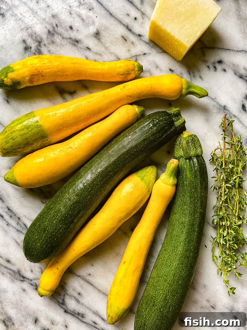 Golden Zucchini with Basil and Pecorino 3 Fresh yellow and green zucchini with a sprig of thyme and a block of Pecorino Romano cheese on a rustic surface.