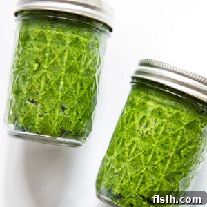 two mason jars filled with green pesto