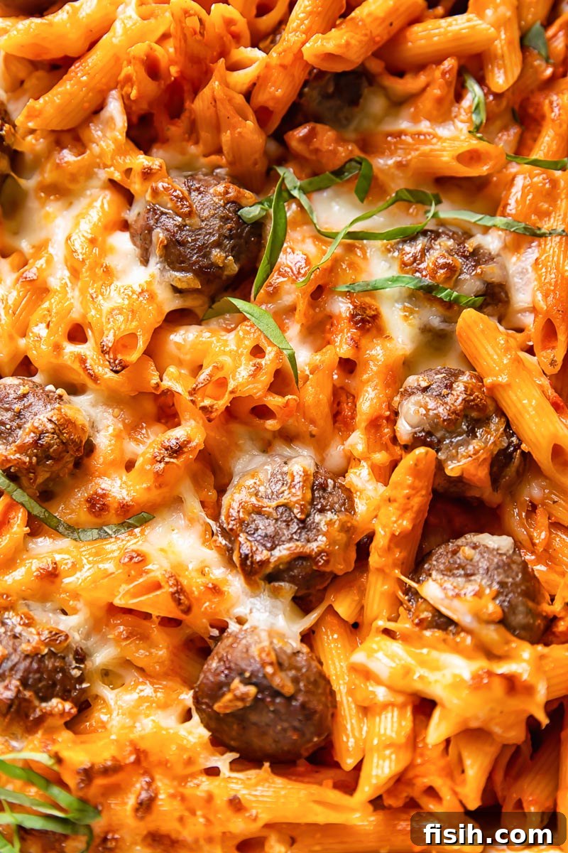 Creamy Baked Vodka Penne with Savory Meatballs 5 close up of baked pasta with meatballs