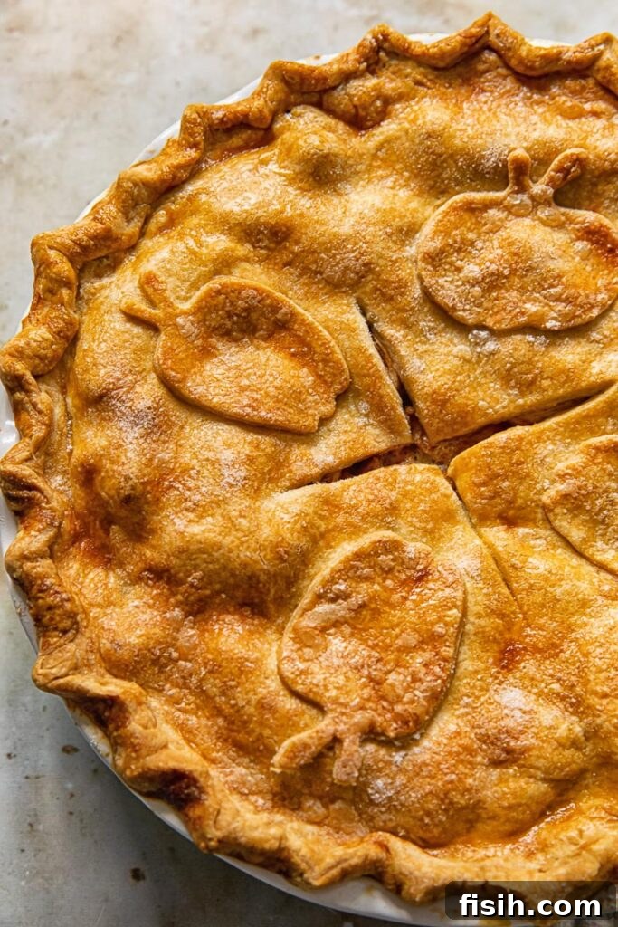 Grandma's Classic Apple Pie 3 Top down view of a whole, freshly baked apple pie with a golden, decorative crust