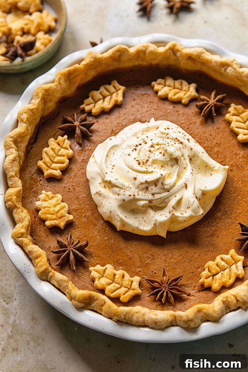 top down view of pumpkin pie topped with whipped cream in the middle