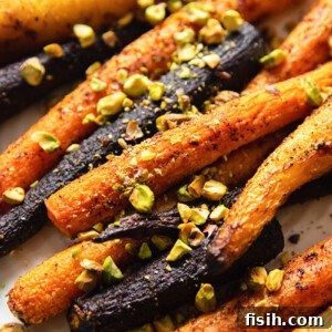 rainbow carrots sprinkled with pistachio nuts close up