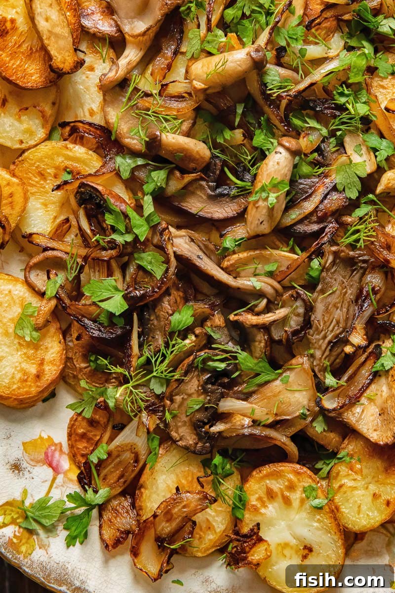 Crispy Oven Potatoes with Mushrooms and Onions 3 fried mushrooms on top of fried potatoes