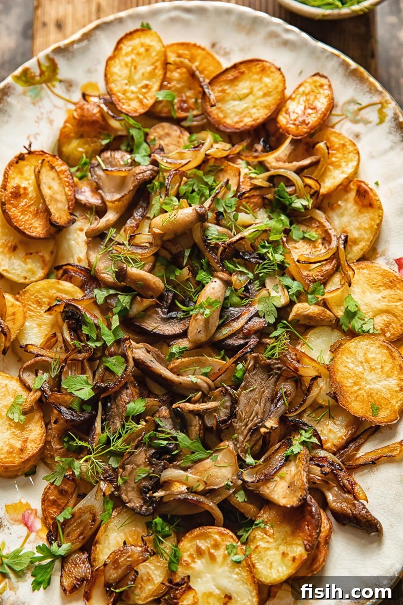Crispy Oven Potatoes with Mushrooms and Onions 5 fried potato disks topped with fried mushrooms and onions on a serving platter