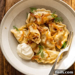 Top down view of sauerkraut and mushroom vareniki, garnished with herbs.