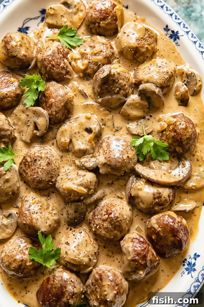 close up of meatballs and mushrooms in a creamy sauce