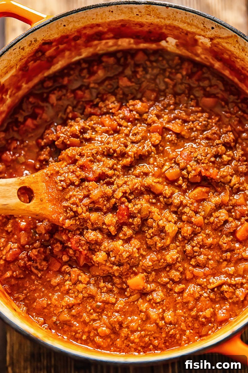 A pot of rich, simmering Tuscan ragu, showcasing the depth of its slow-cooked flavors