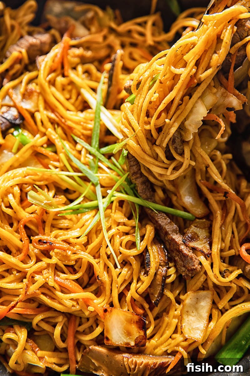 close-up of Japanese yakisoba noodles stir-frying in a pan